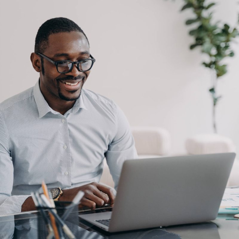 smiling-african-american-man-wearing-glasses-worki-CWQK3CT smiling-african-american-man-wearing-glasses-worki-CWQK3CT